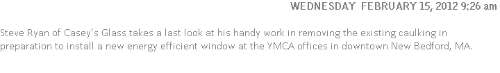 Steve Ryan of Casey's Glass takes a last look at his handy work in removing the existing caulking in preparation to install a new energy efficient window at the YMCA offices in downtown New Bedford, MA.