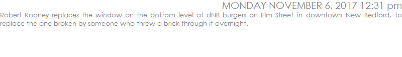 Robert Rooney replaces the window on the bottom level at dNB burgers on Elm Street in downtown New Bedford, to replace the one broken by someone who threw a brick through it overnight.