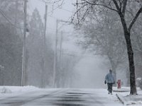 A man walks up Fort Street in Fairhaven as snow begins to fall across the region.   [ PETER PEREIRA/THE STANDARD-TIMES/SCMG ]