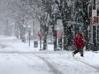 A man crosses William Street in downtown New Bedford as another late season snow storm covers the area.   [ PETER PEREIRA/THE STANDARD-TIMES/SCMG ]