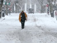 A man makes his way up William Street on the tire tracks as another late season snow storm covers the area.   [ PETER PEREIRA/THE STANDARD-TIMES/SCMG ]