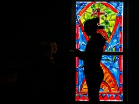 Audrey Thomson is silhouetted in front of a colorfully painted glass door of the just opened What the Taco in Mattapoisett, as she takes a customers lunch order.