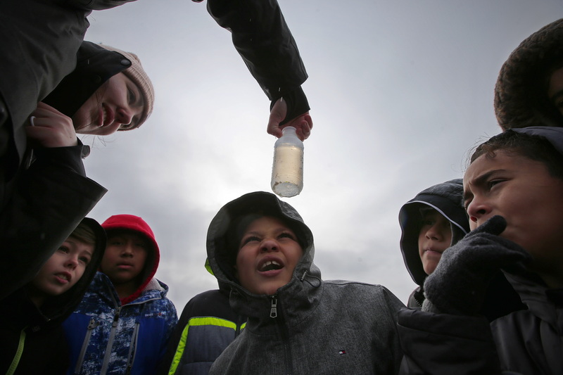 Taevias Oliver-Agee, 11, and fellow Haiden McFadden fifth graders struggle to find the plankton swimming in the water sample collected by Colette Tweeddale of the Buzzards Bay Coalition during their field trip to East Beach in New Bedford, MA as part of their weekly Sea Lab studies. PHOTO PETER PEREIRA