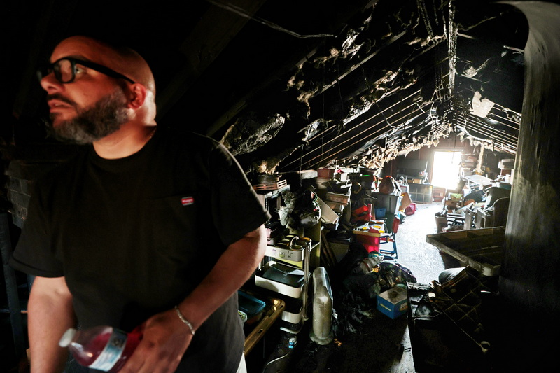 A.J. Fortes, facilities manager, takes a look at the devestation caused by an overnight fire to the upper level of the Nazarene Christian Academy on Hathaway Road in New Bedford, MA. PHOTO PETER PEREIRA