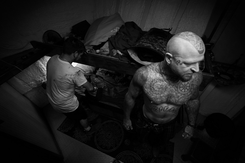 Grayson Rogers, left, and James Williams, who has nautical tattoos covering his torso, head below deck to escape the heat after repairing the dredges on the scalloper Amanda Ashley, a vessel docked in New Bedford, MA and originating from North Carolina.  PHOTO PETER PEREIRA
