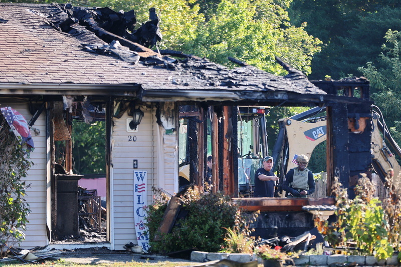 Travis Rebello, State Fire Marshal Joint Hazards Incident Response Team and State Police bomb technician Jerry Harris are seen through whats left of the window of the home on 20 Sagamore Drive in Dartmouth, MA.  One resident was taken to the hospital. PHOTO PETER PEREIRA