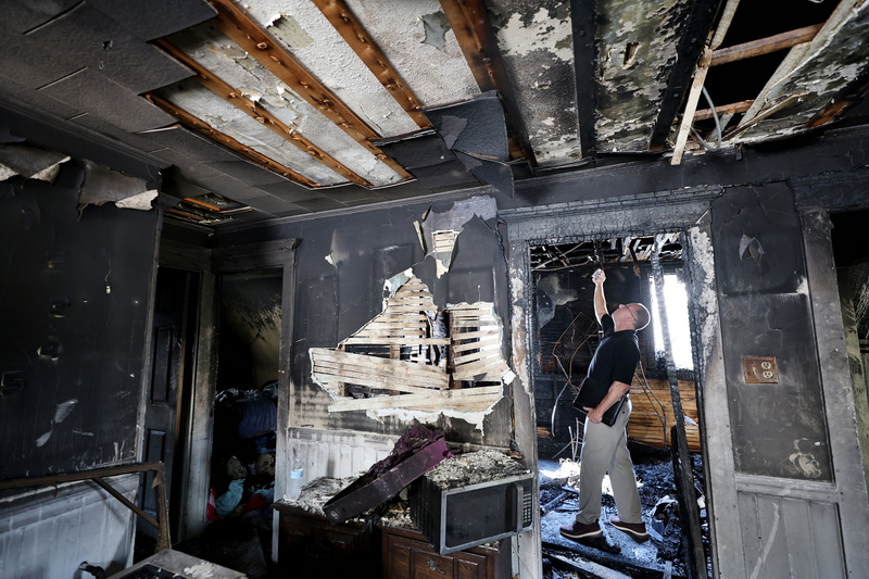 Ed Marinilli, public adjuster, documents the aftermath of an overnight third-floor fire at 53 Katherine Street in New Bedford, MA. PHOTO PETER PEREIRA