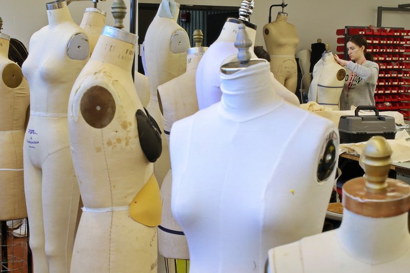 Aleta Deyo is surrounded by mannequins as she tests her fashion design on one in fashion design's draping class at UMass Dartmouth. PHOTO PETER PEREIRA