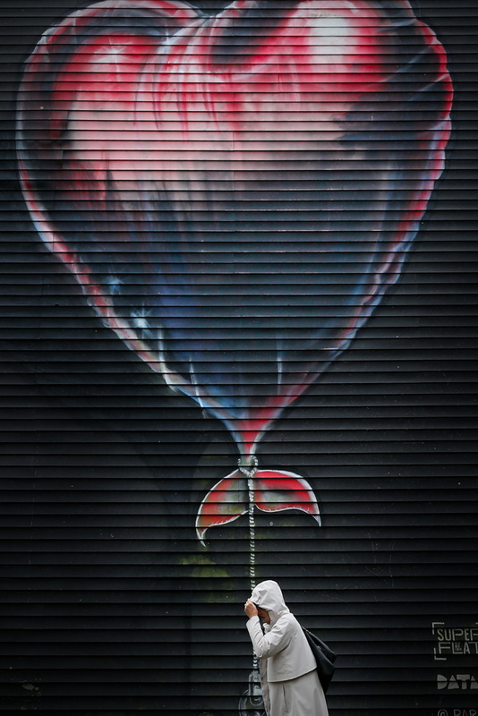 A plane flying out of Ronald Regan International Airport flies across the sky behind the American flags in front of the Washington Monument in Washington D.C. PHOTO PETER PEREIRA