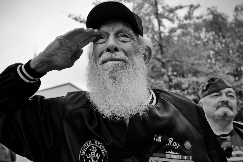 Vietnam era Navy veteran, Ray Landry, salutes fellow veterans marching in the 2025 Veterans Day Parade in New Bedford, MA. PHOTO PETER PEREIRA