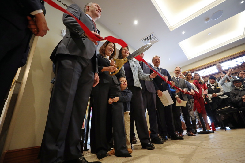 Wesley Freshman, 3, rushes to his grandmothers side just as Rosemary Gill, Zeiterion President & CEO, cuts the ribbon during the Zeiterion reopening ceremony of the historic downtown New Bedford, MA theater after an extensive eighteen month restoration. PHOTO PETER PEREIRA