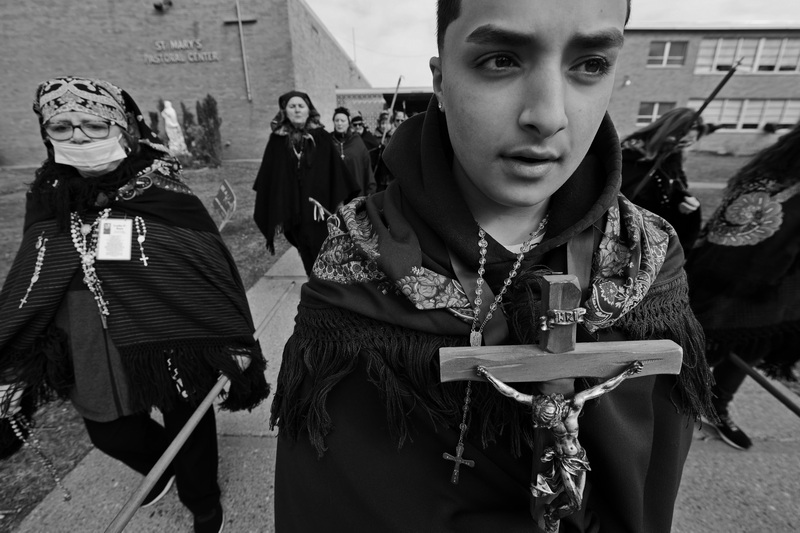 Aiden Sousa guides fellow Romeiros as they leave St. Mary's Pastoral Center in New Bedford, where they had breakfast before proceeding to their next destination during a day-long pilgrimage to several churches throughout the city. The Romeiros uphold a centuries-old Azorean custom, common on the island of S�o Miguel, where groups of men walk around the island visiting churches and praying for divine help, especially for protection and forgiveness. This tradition was brought to the U.S. by immigrants in the 1980s. PHOTO PETER PEREIRA