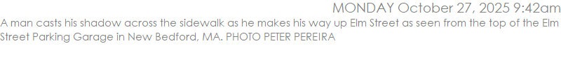 A man casts his shadow across the sidewalk as he makes his way up Elm Street as seen from the top of the Elm Street Parking Garage in New Bedford, MA. PHOTO PETER PEREIRA